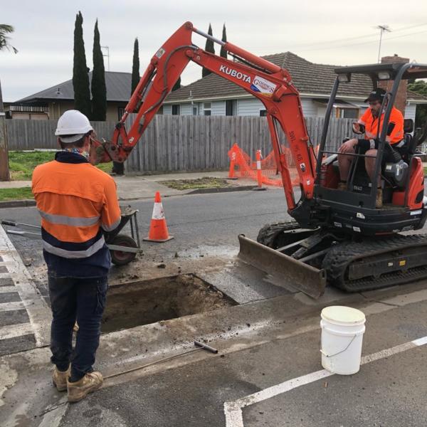 Commercial plumbing experts doing work at a Geelong road.